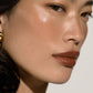 Close-up of a woman's face with a neutral background (Natural)