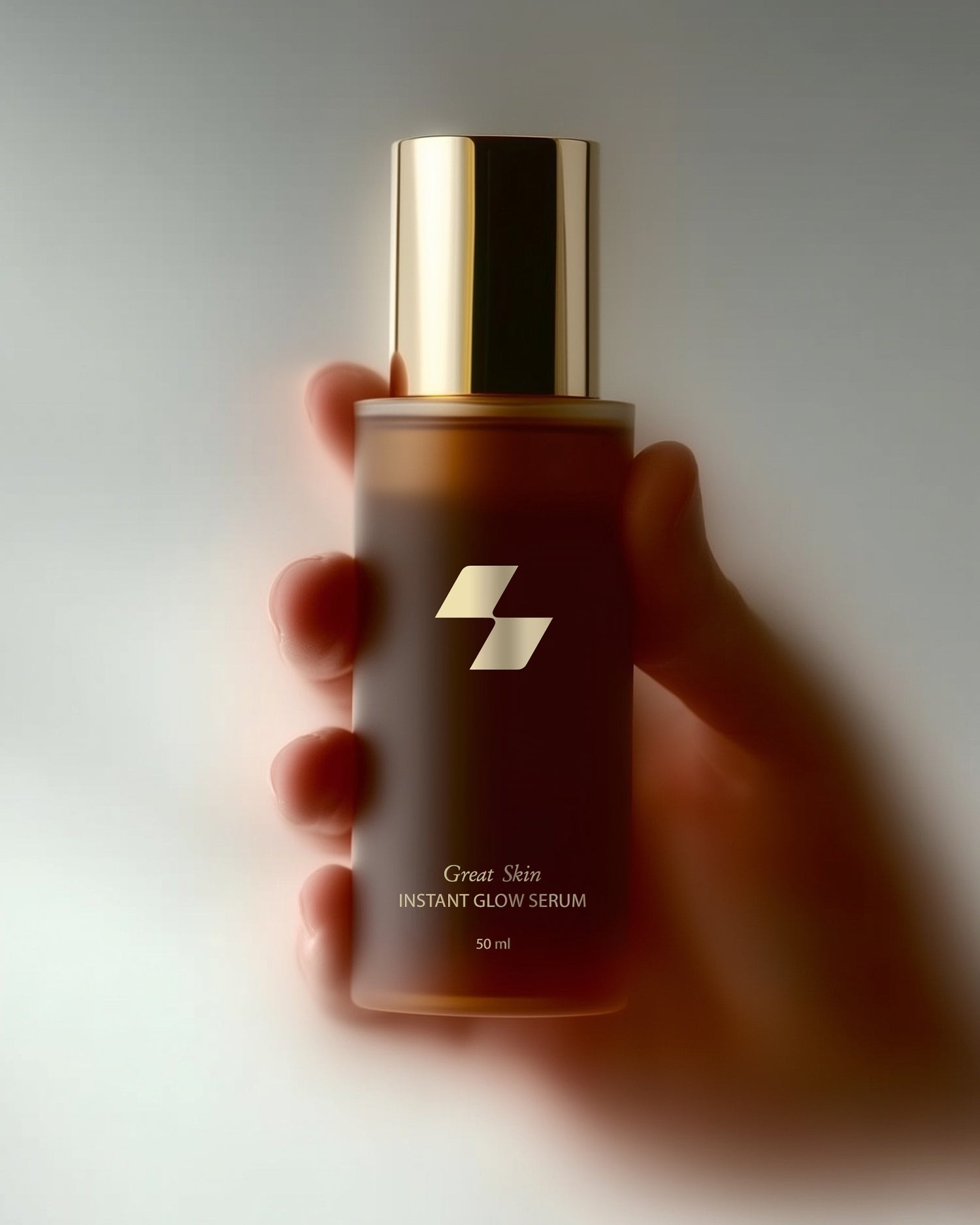 Hand holding a serum bottle with a gold cap against a neutral background