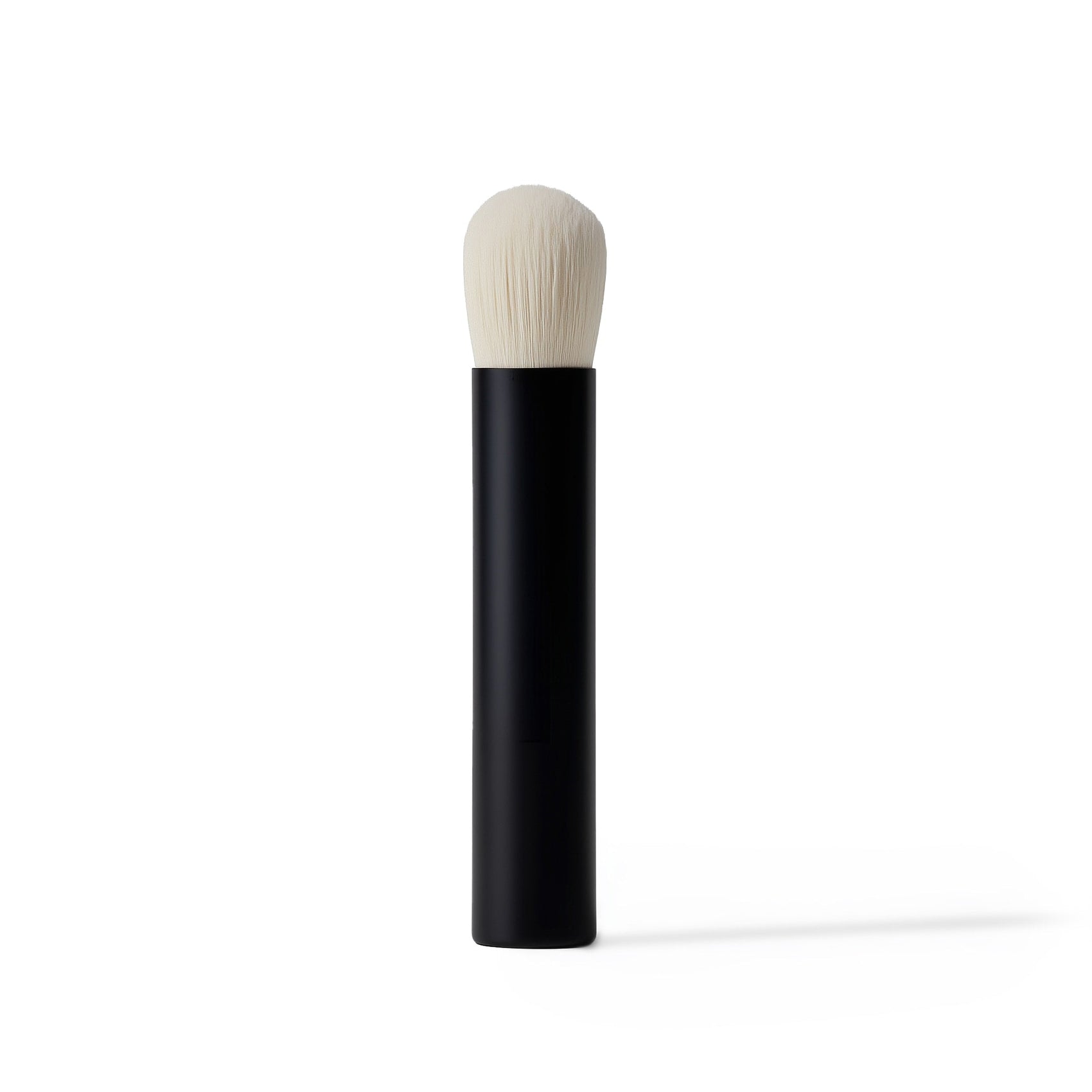 Makeup brush with black handle and white bristle head on a white background