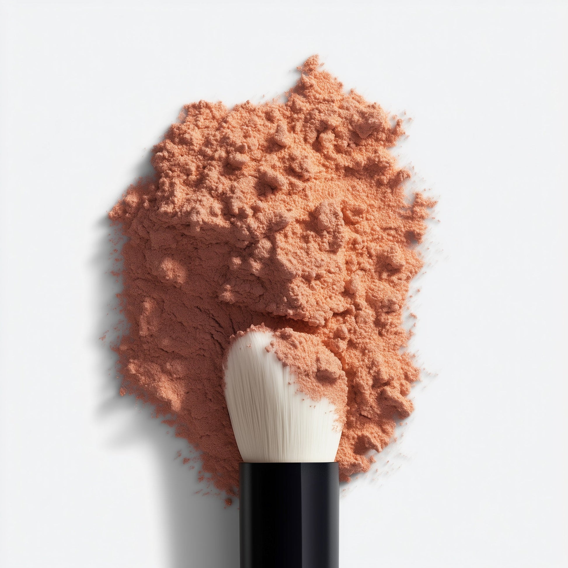 Pile of pink makeup powder with a brush on a light gray background