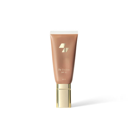 Cosmetic tube labeled 'The Uniform' on a white background (Medium beige)