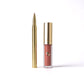 Lipstick with gold casing on a white background