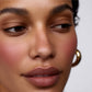 Close-up of a person's face with a neutral background (Red)