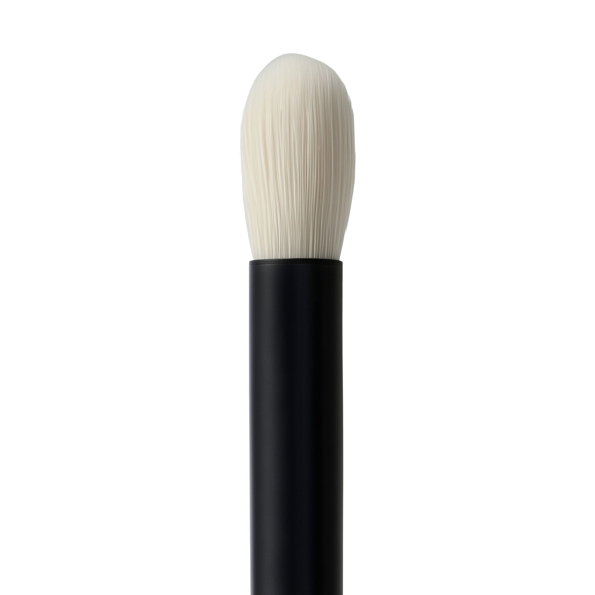 Makeup brush with black handle and white bristles on a white background