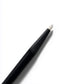 Black makeup pencil with white cap on a white background