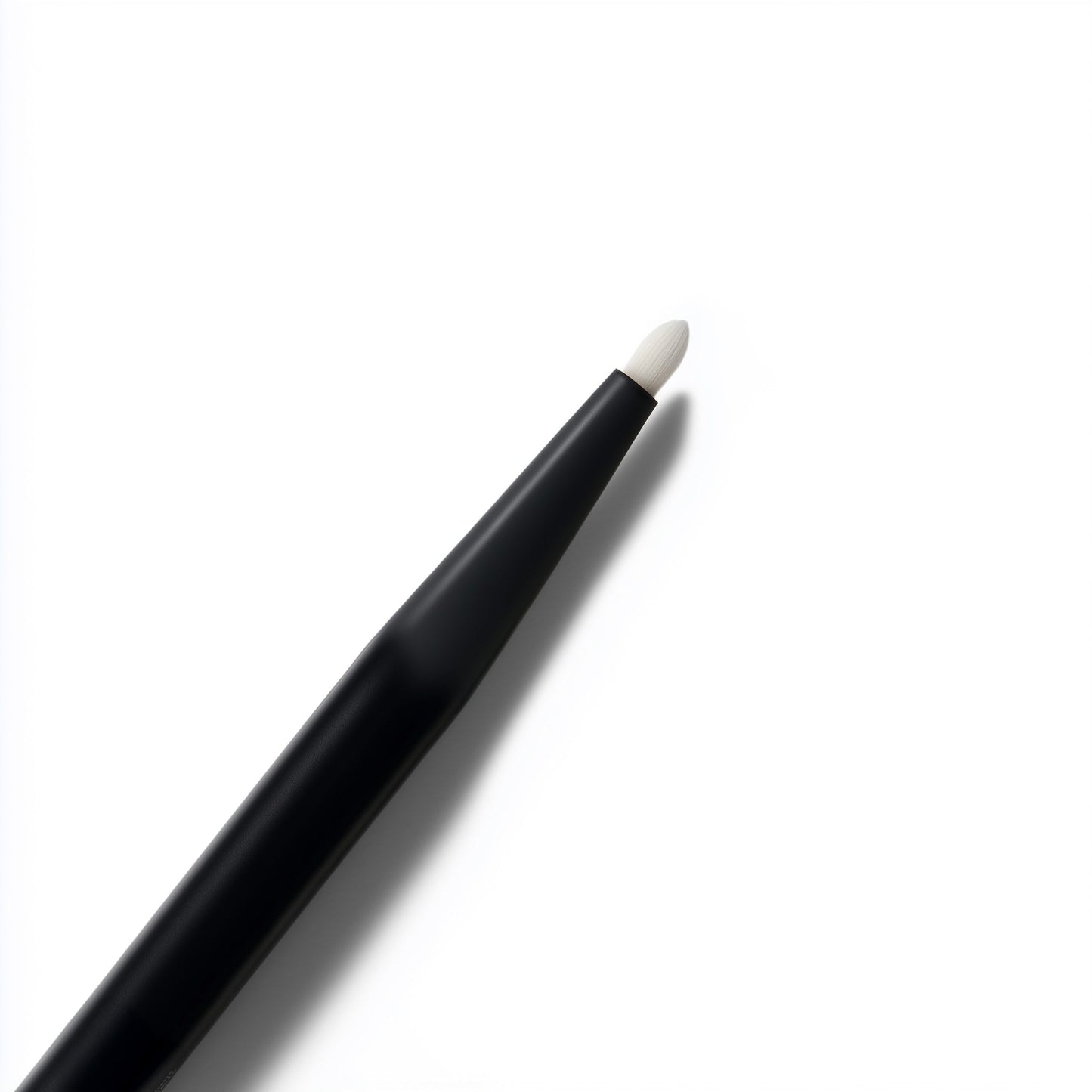 Black makeup pencil with white cap on a white background