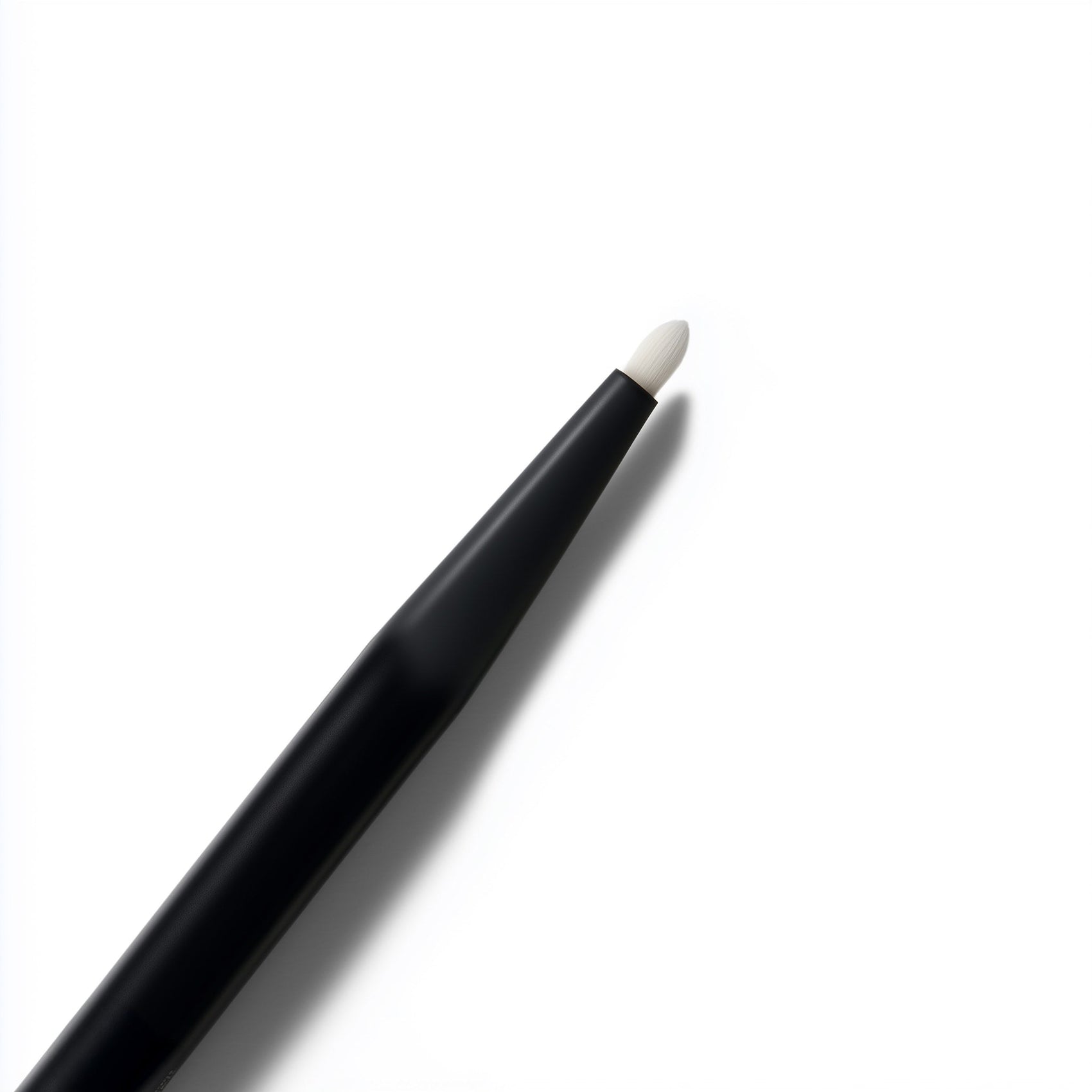 Black makeup pencil with white cap on a white background