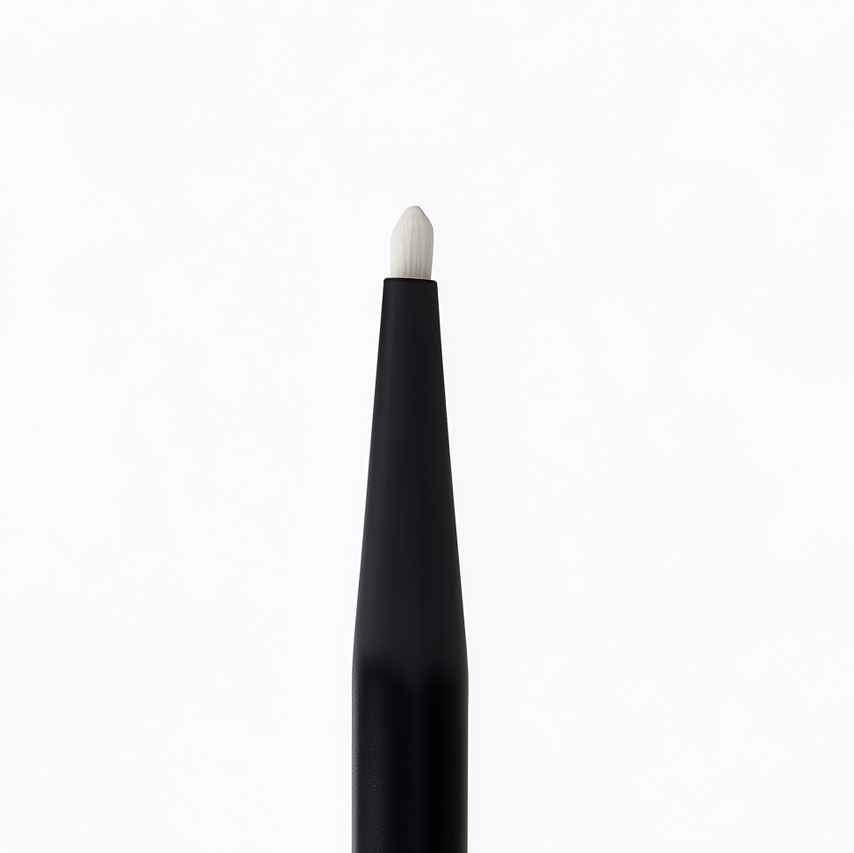 Black makeup brush with white bristle tip on a white background