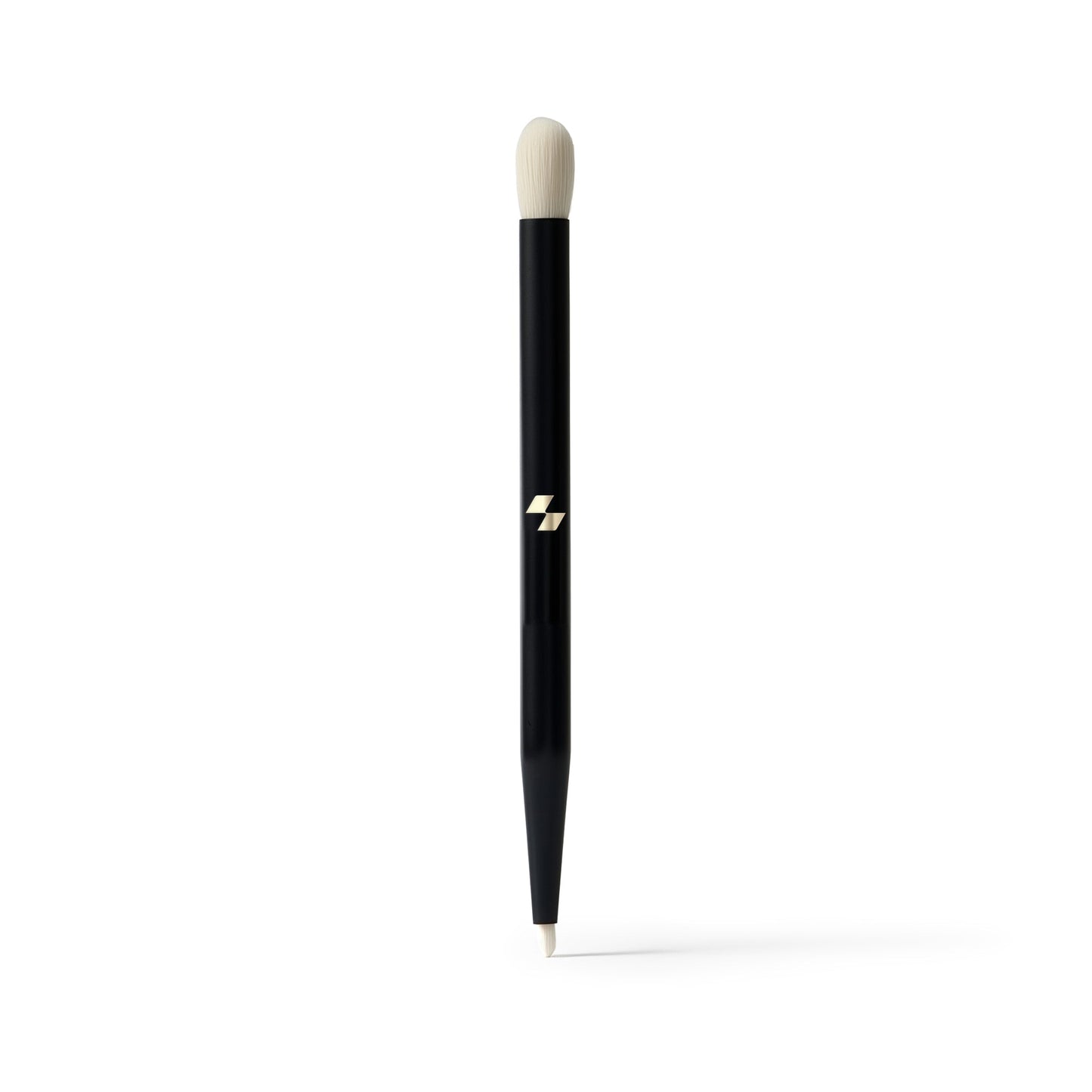 Black makeup brush with a white bristle tip on a white background