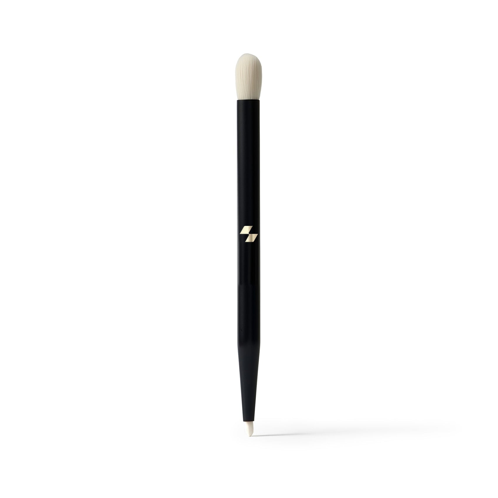 Black makeup brush with a white bristle tip on a white background
