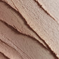 Close-up of layered makeup product with a gradient effect