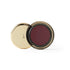 Cosmetic compact with gold lid and red interior on a white background (Marsala)