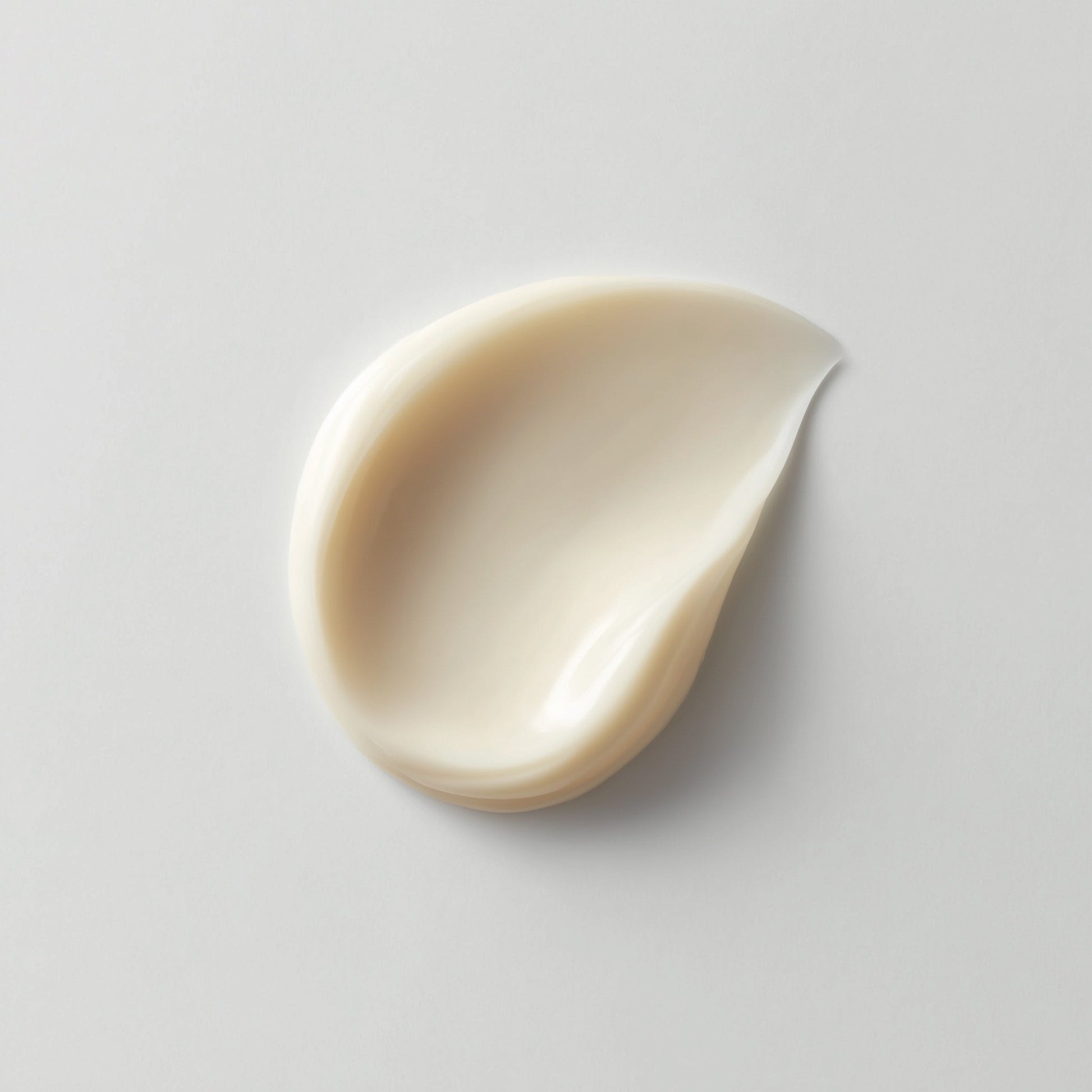 Beige cream smear on a light gray background