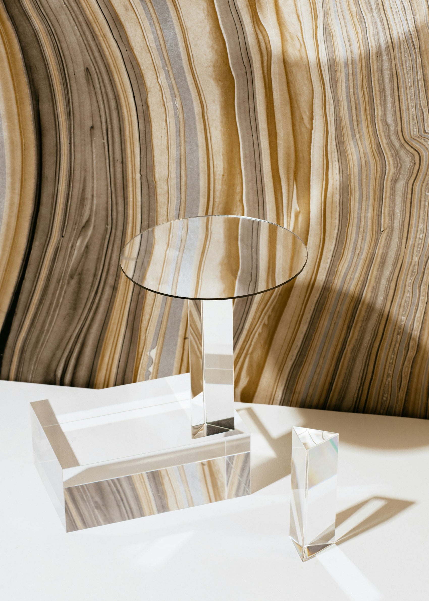 Glass table against a textured wall with wavy patterns
