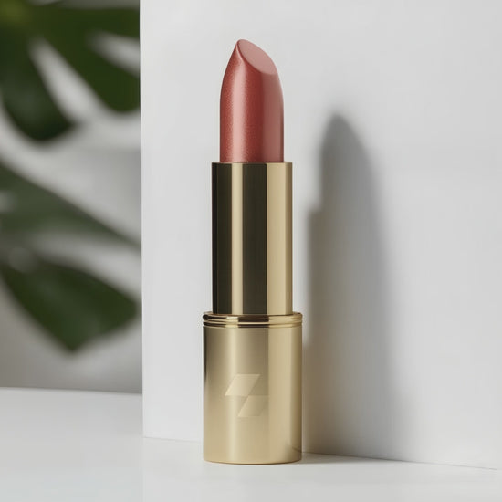 Red lipstick with gold case on a white background 
