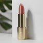 Red lipstick with gold case on a white background 