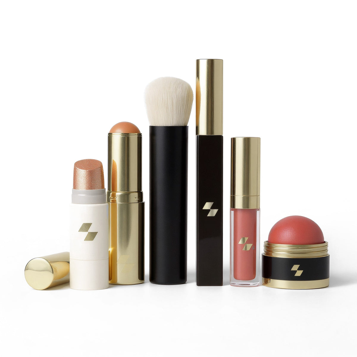 Collection of makeup products including lipsticks and brushes on a white background