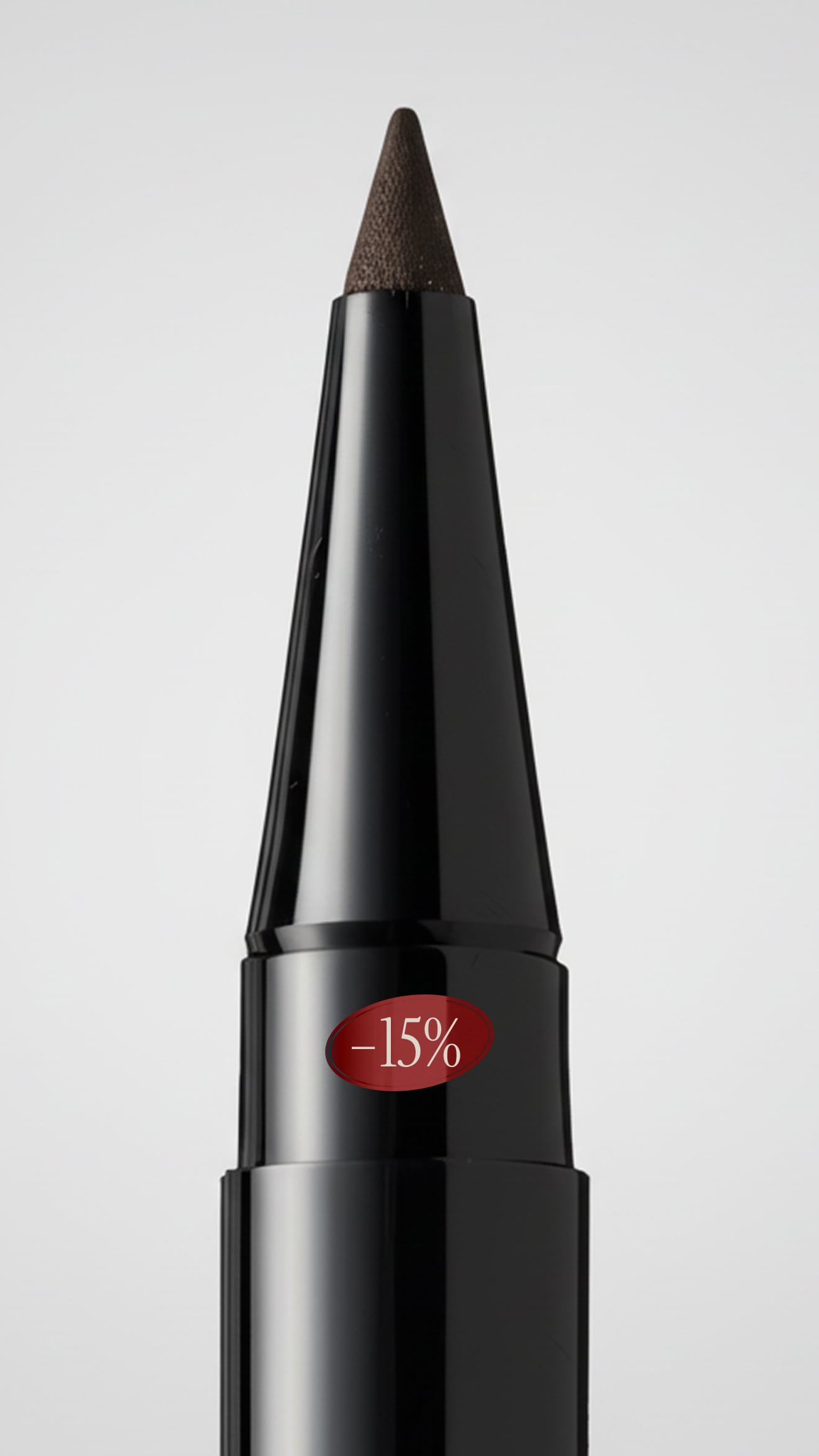 Black eyeliner pencil with brown tip on a gray background