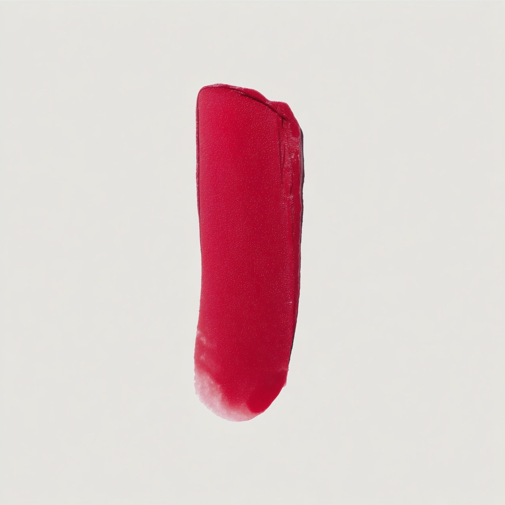 Red lipstick swatch on a light gray background (Neon Red)