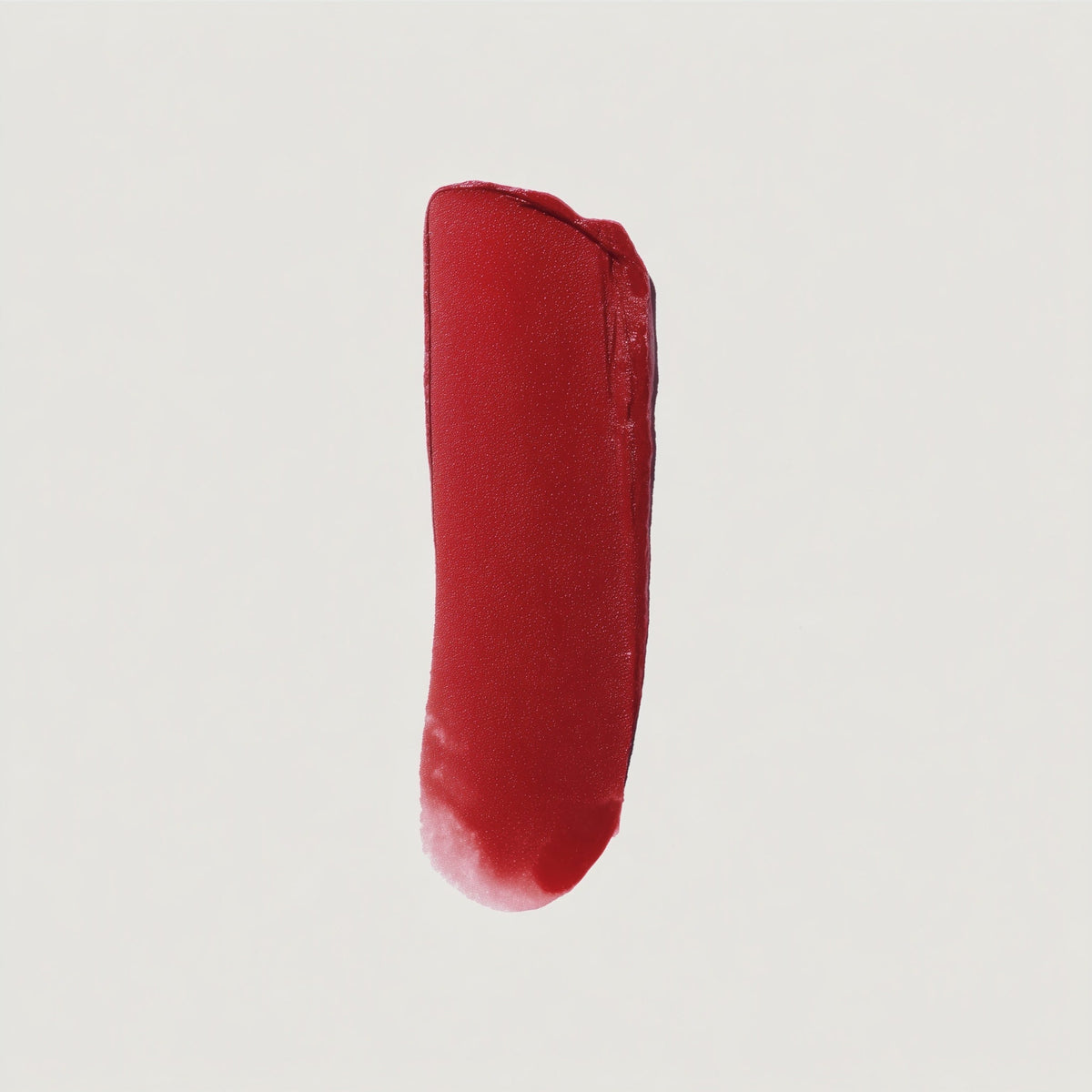 Red lipstick swatch on a light gray background (Red)