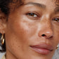 Close-up of a woman's face with a neutral expression (Medium brown)