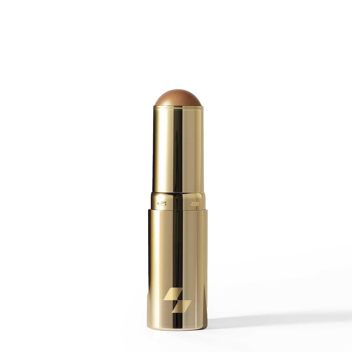 Gold lipstick with a brown shade on a white background (Medium brown)