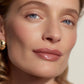 Close-up of a woman's face with a soft focus on her eyes and lips  (Medium Orange)