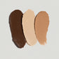 Three swatches of different shades of makeup on a light gray background