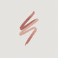 Three swatches of pink lipstick on a beige background (Brown)